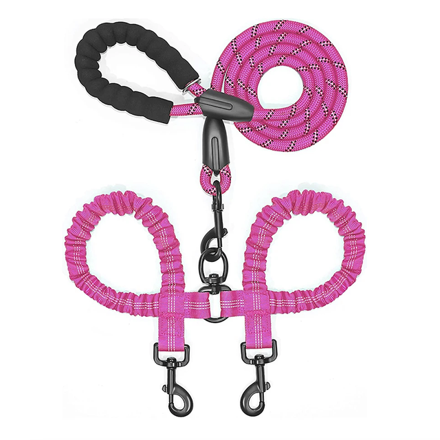 Double dog leash coupler by Zuka & Co. connecting two dogs for a walk, featuring durable clips and adjustable length.